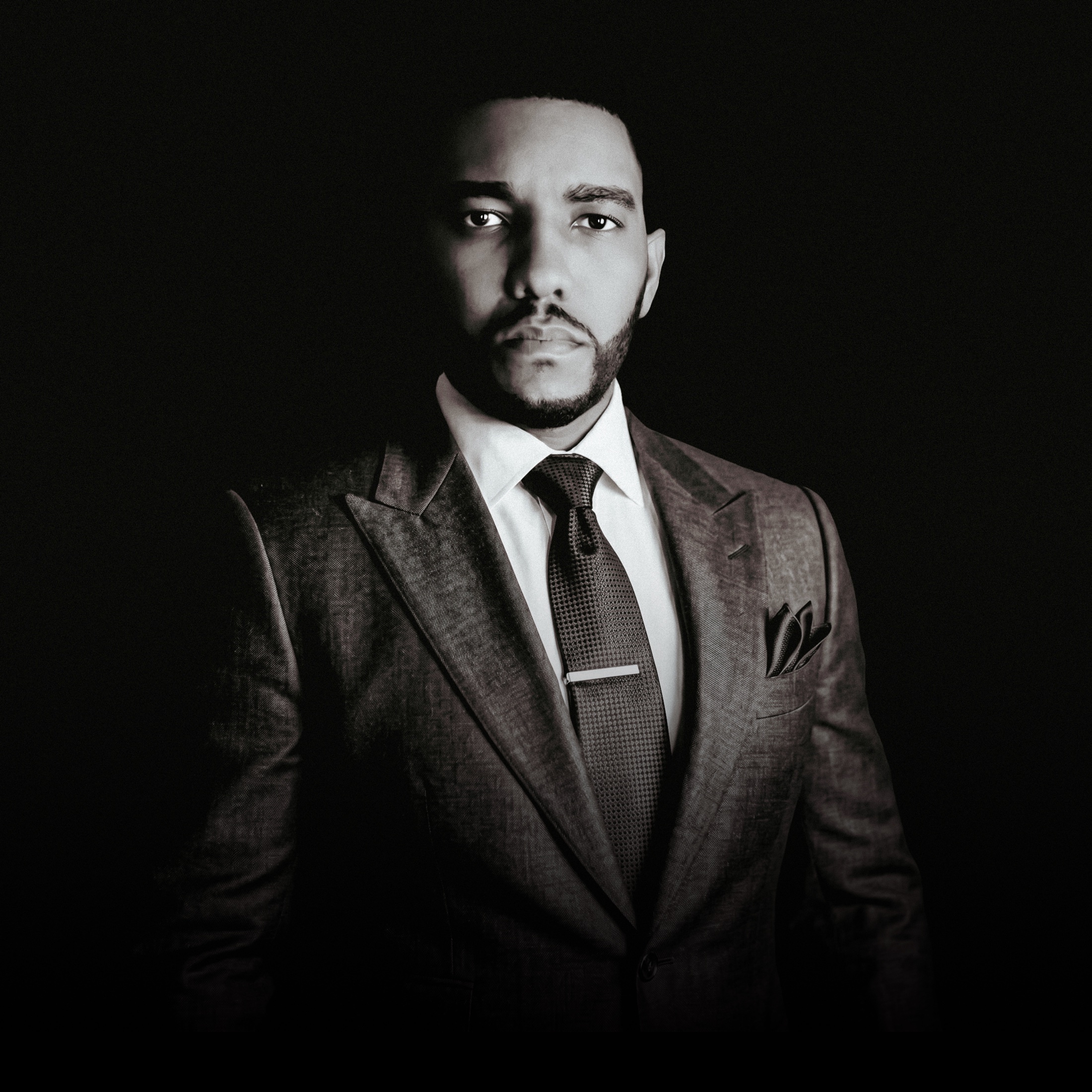 Michael Harte Jr. standing in a black suit